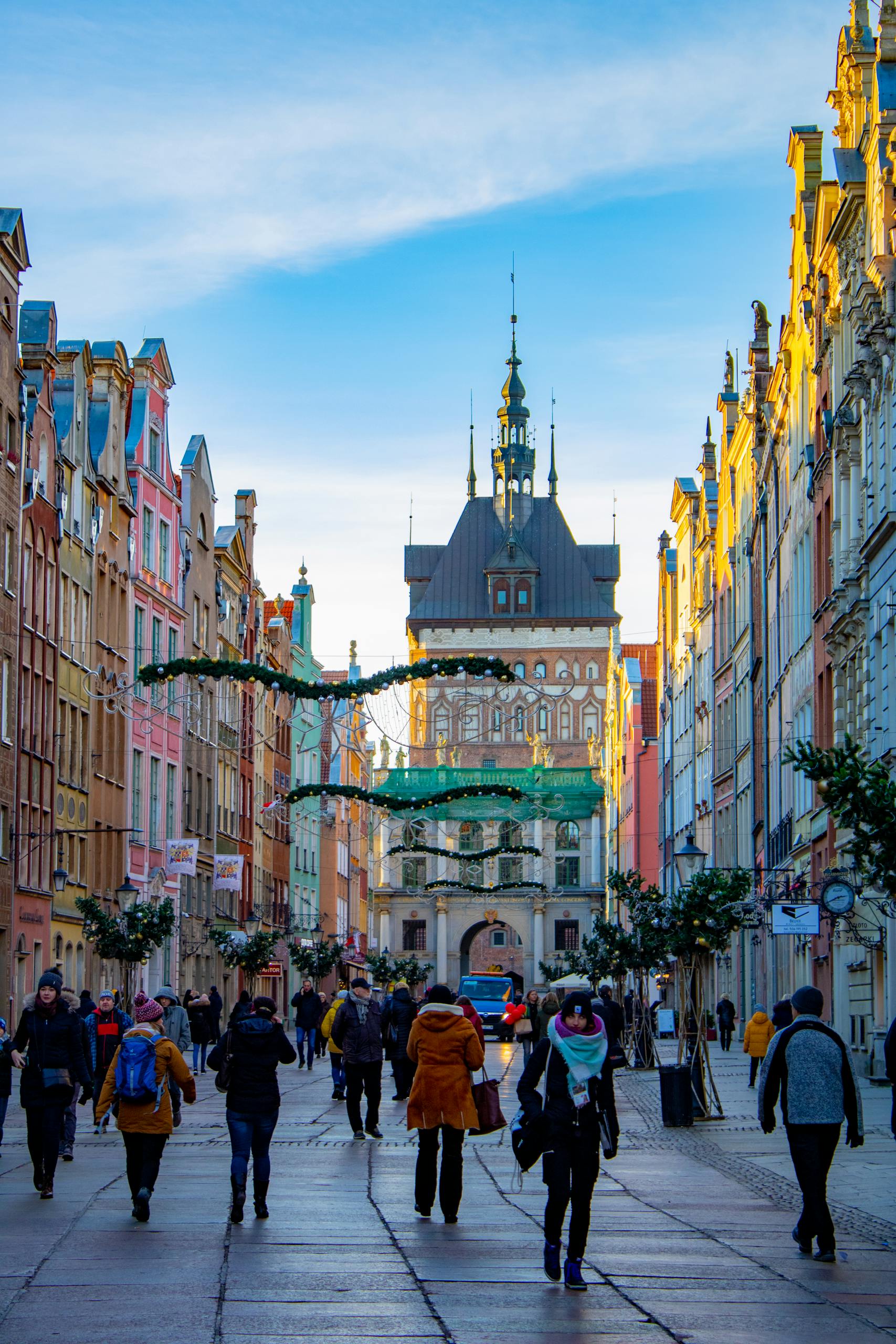 Vibrant street view of Gdansk with people exploring the colorful architecture and historic buildings.